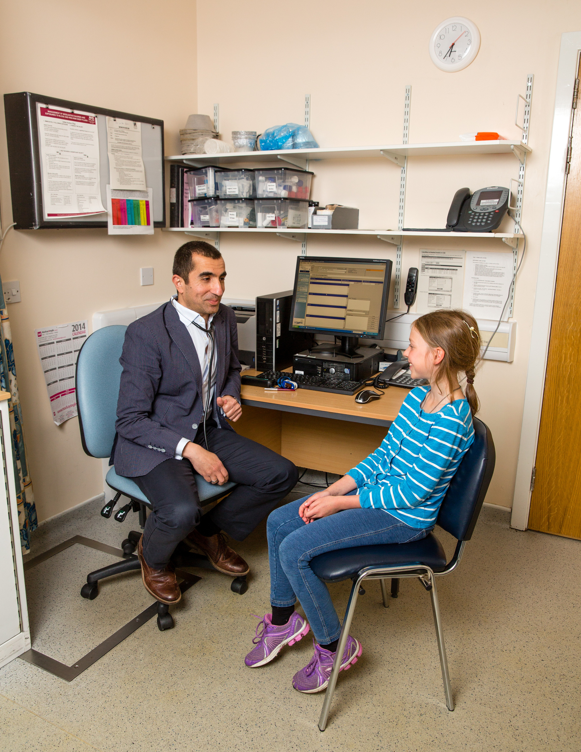 GP and teenage patient in surgery
